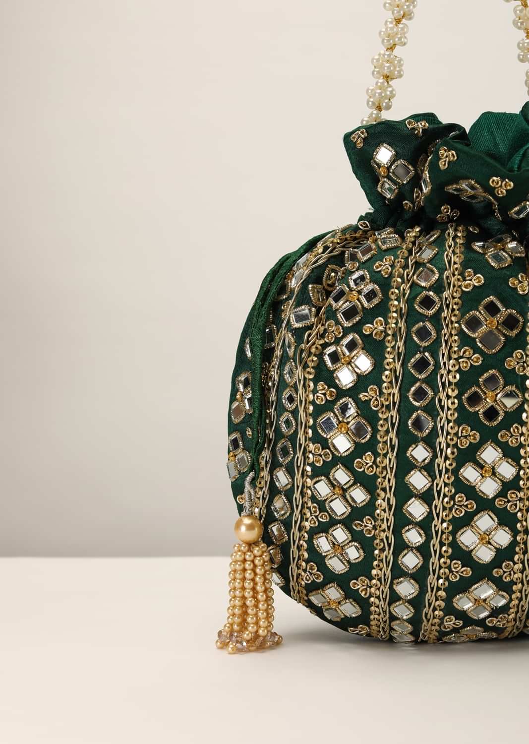 Bottle Green Potli In Satin With Hand Embroidery Detailing Using Mirror And Zardosi In Geometric Design