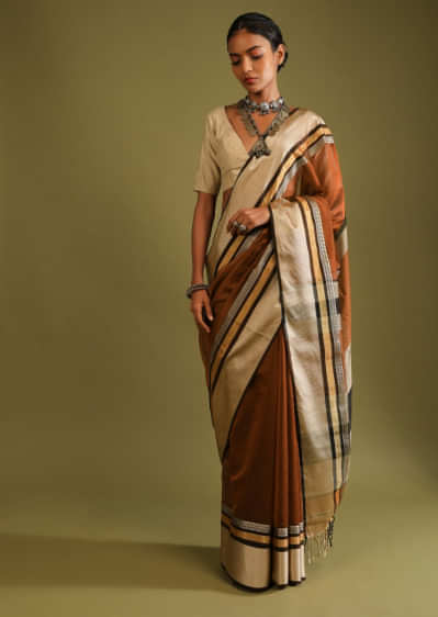 Clay Brown Saree In Tussar Silk With Black And Gold Woven Border And Grey And Gold Stripes On The Pallu  