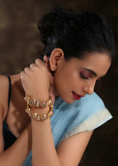 Gold Plated Kundan Bangles With Pink And Green Stones And Embossed Temple Work By Paisley Pop