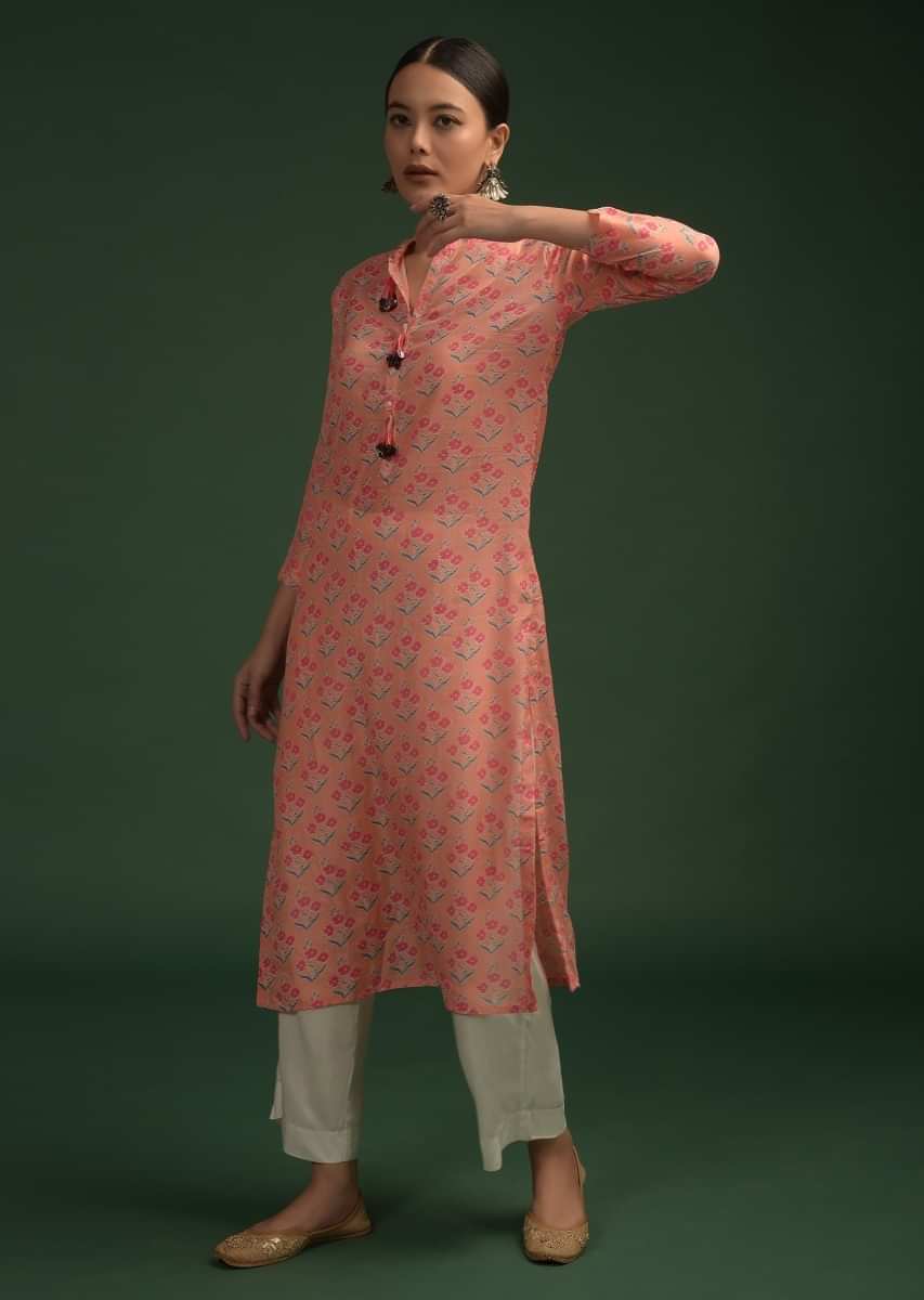 Peach Straight Cut Kurti In Cotton With Printed Floral Buttis And Tassels On The Placket 
