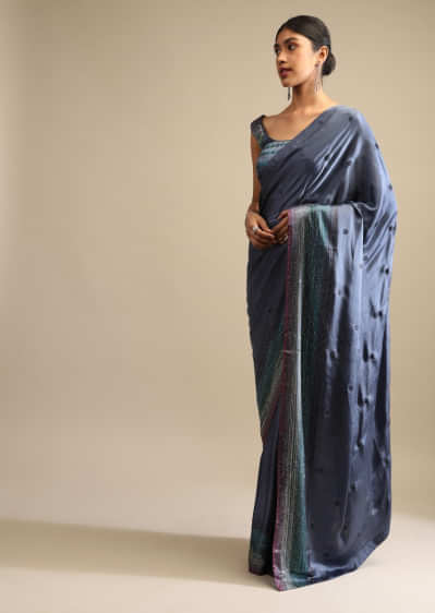 Pigeon Blue Saree In Satin Embellished With Multi Colored Kundan Work On The Border And Butti Work  