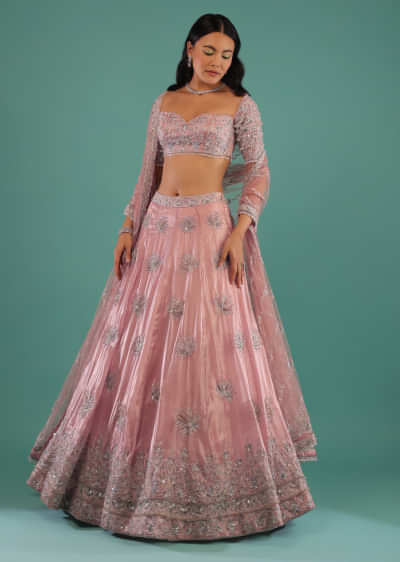 Powder Pink Lehenga And Off Shoulder Crop Top In 3D Floral Motifs Embroidery Paired With A Matching Net Dupatta