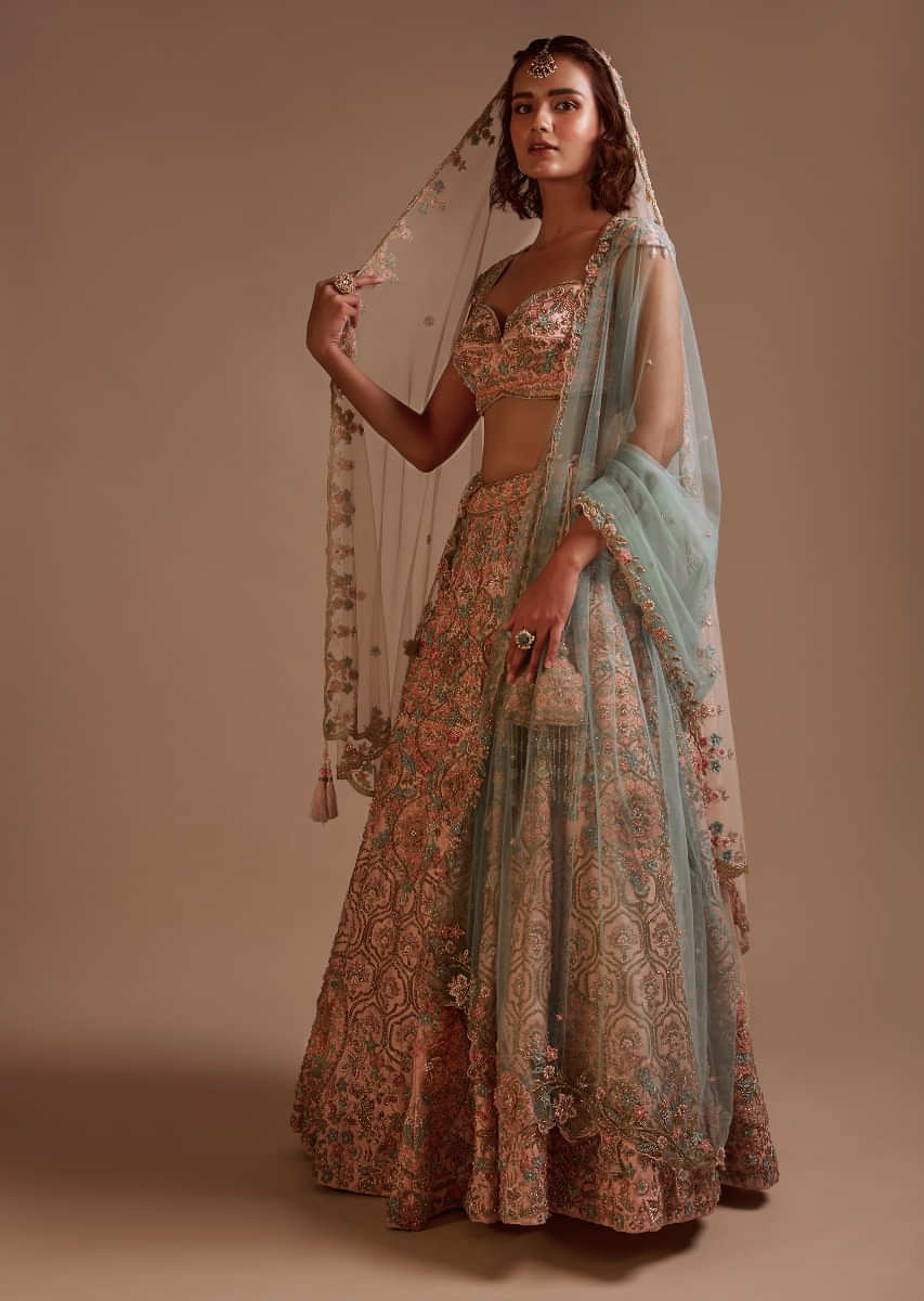 Powder Pink Lehenga In Raw Silk Heavily Hand Embroidered In Floral And Moroccan Motifs Along With 3D Flower Detailing 